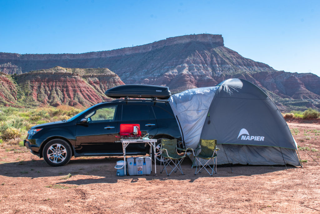 Explore the best car camping gear for overlanding & off-roading in a camper van & truck. Our essential item checklist & packing list includes window covers, tents, heaters, stoves & vehicle setup.
